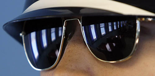 Reflection of a meeting room on a South Korean soldier's glasses.  This meeting room is in the DMZ, the dividing line between North Korea and South Korea.  Since their armistice in 1953 the two countries have technically remained at war.  AP Photo / Lee Jin-man