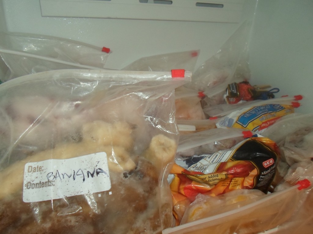 Three rows of frozen fruit on the top shelf of my freezer.